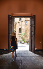 Woman entering an open door
