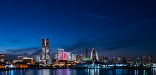 Fototapeta na wymiar Wide panorama of Yokohama Minato Mirai 21 seaside urban area in Japan at dusk