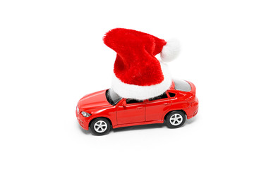 Red toy car in a New Year's cap on a white background