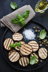 Sliced grilled eggplant with capers, sea salt and fresh basil