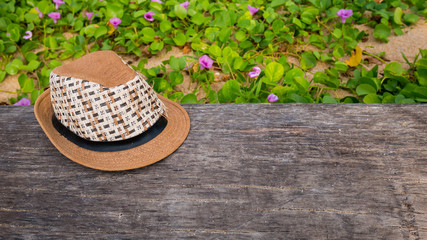 hat on the timber with grass background.