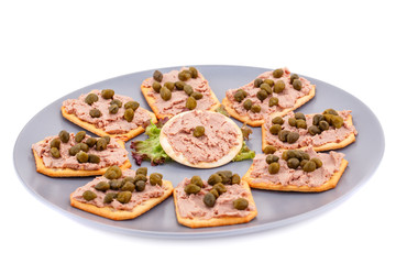 Meat pate with capers on crackers