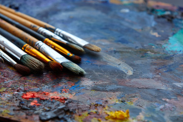 Paint brushes on a palette.