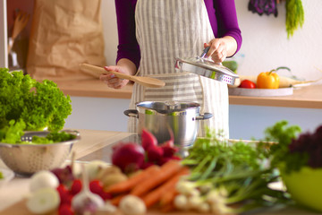 Young Woman Cooking in the kitchen. Healthy Food