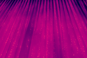 Purple or violet abstract background. Curtain with glowing lights. Christmas abstraction. The texture of the curtain