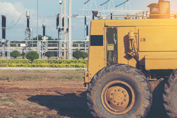 Grader leveling landfill on construction site before kick off project
