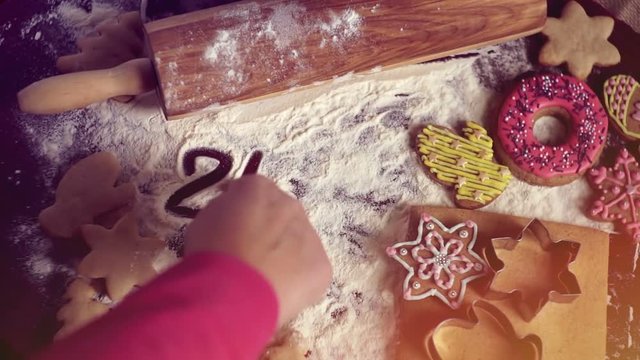 Christmas baking background. The girl writes on a table 2017