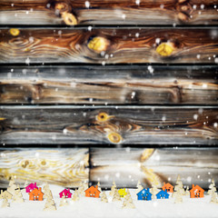 Christmas background with small wooden houses, Christmas trees and snow
