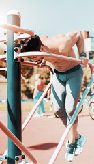 Muscular man during his workout outdoors