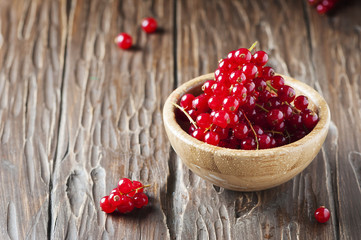 Macro photo of red currant on the wooden table