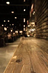Photo sur Aluminium Restaurant Empty wood table top of bar with blur of cafe restaurant in dark