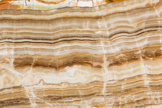 Brown onyx stone texture with abstract lines.