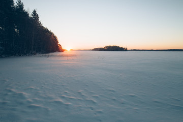 Sunset winter landscape with snow-covered field. Concept for your snow design
