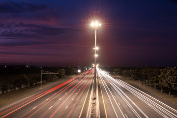 Fototapeta na wymiar Speed Traffic at light trails on motorway highway at night,backg