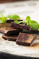 Brown chocolate and mint on the wooden table