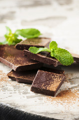 Brown chocolate and mint on the wooden table