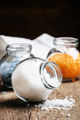 White sea salt for baths, vintage wooden background, selective f