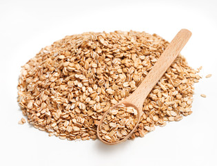 Wooden spoon and heap of oats on white background. Healthy food. Copy space. Close up, high resolution product