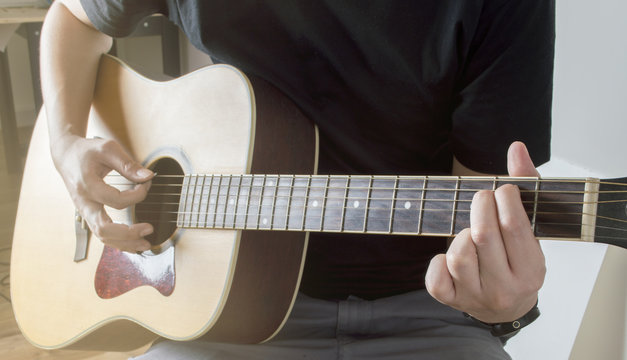 Men Playing Acoustic Guitar Closeup cord Em with sunlight