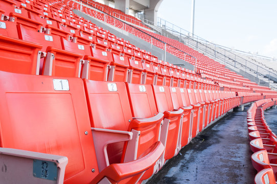 Empty orange seats at stadium,Rows of seat on a soccer stadium