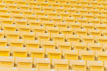 Empty yellow seats at stadium,Rows of seat on a soccer stadium,select focus