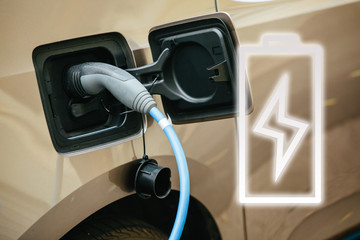 Eco-friendly electric vehicle. The charger charges the battery. battery sign.