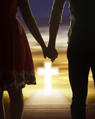 Young couple looking the shining cross