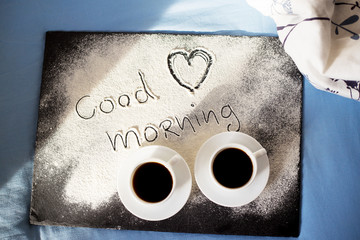 good morning inscription flour on a board with cups of coffee, heart Valentine's day