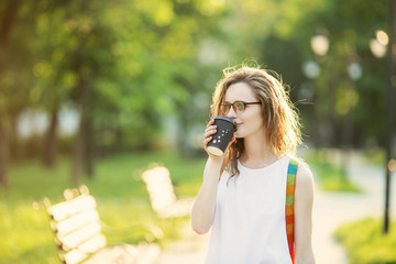 Fototapeta premium Portrait of lovely urban girl with paper cup in her hands
