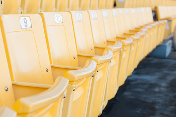 Naklejka premium Empty yellow seats at stadium,Rows of seat on a soccer stadium,select focus