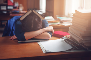 Woman sleeping with a book on her head.