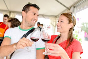 Couple tasting wine at an event
