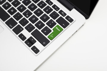 Laptop's keyboard with green Share key and copyspace