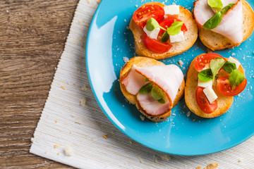 Bruschetta with tomato, cheese and bacon