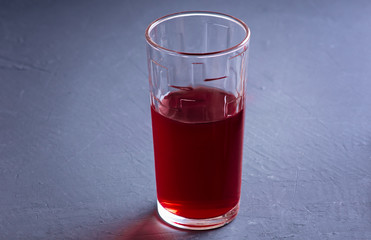 Pomegranate juice with pomegranate on a dark board