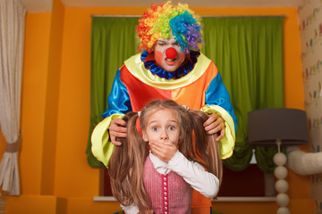 Little girl was frightened of the clown.