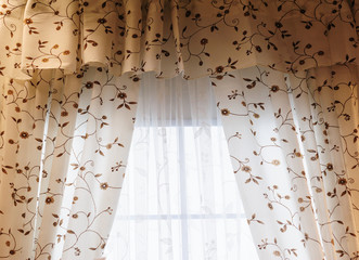 Beautiful curtains with flowers paint in a room