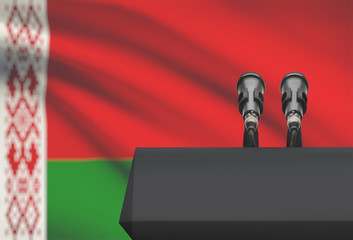 Pulpit and two microphones with a national flag on background - Belarus