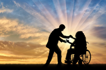 Fototapeta na wymiar Disabled person woman in wheelchair get help