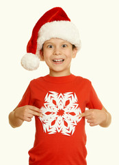 boy in santa hat portrait with big snowflake on white isolated - winter holiday christmas concept, yellow toned