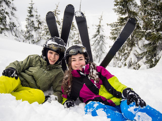 Teenage girl and boy skiing 