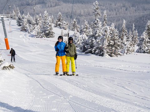 Teenage girl and boy skiing 