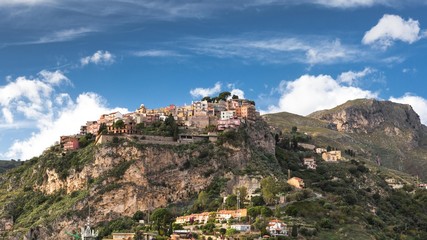 A small town Castelmola on a top of a hill agains the blue sky, Sicily, Italy, Europe.
