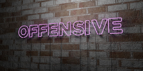 OFFENSIVE - Glowing Neon Sign on stonework wall - 3D rendered royalty free stock illustration.  Can be used for online banner ads and direct mailers..