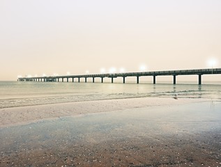 Autumn misty morning on wooden pier above sea. Depression, dark  atmosphere.