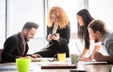 Business people working in team in board room in office. Happy coleagues discussing business criteris for their company, enterprise or firm.