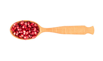 Pomegranate seeds in spoon