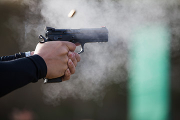 The sparks from the gun, Bullets shot out of the barrel and smok © peterkai