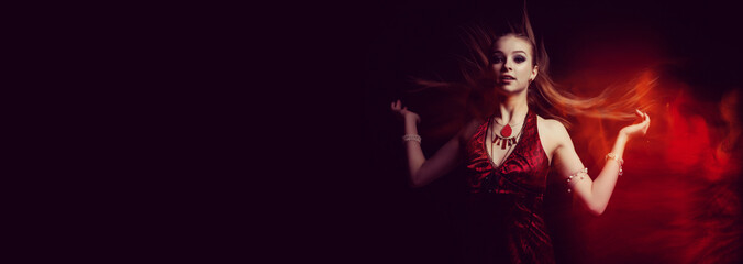 The girl in a red dress in fire flame