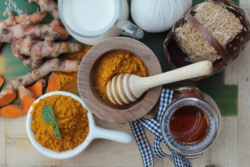 Turmeric powder with honey and milk for scrub.